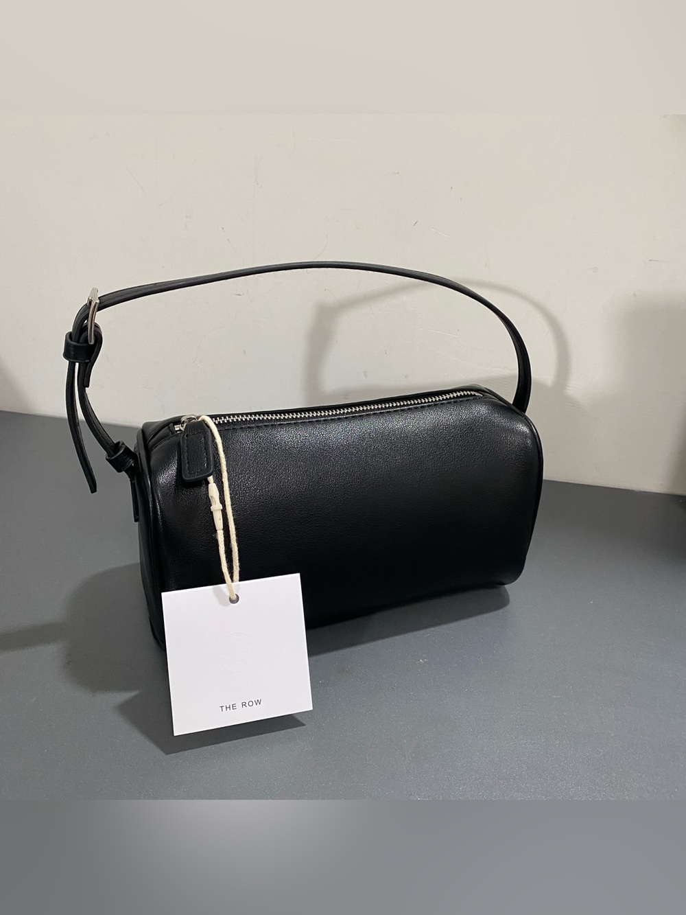 The Row Black Leather Barrel Shoulder Bag with Adjustable Strap